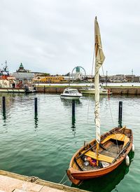 Ship moored on river against sky