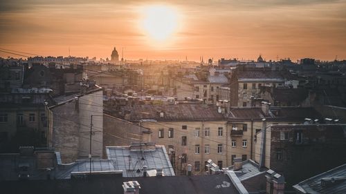 Aerial view of town against sky during sunset