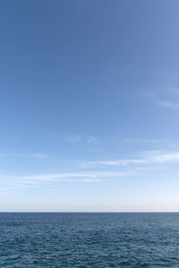 Scenic view of sea against blue sky