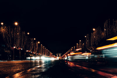 Illuminated city against sky at night