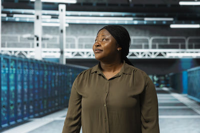 Portrait of young woman standing in city