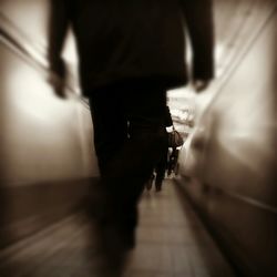 Woman standing on escalator