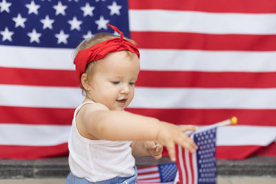 Portrait of cute girl holding american flag