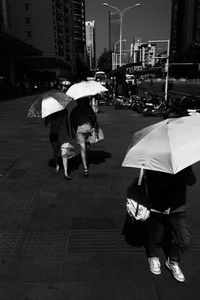 People walking on wet street in city