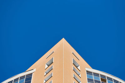 Low angle view of building against clear blue sky