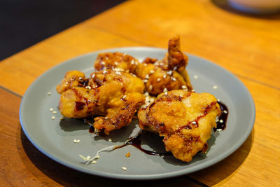 High angle view of fried chicken in bowl on plate