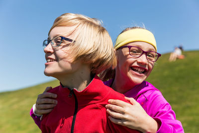 Portrait of happy mother with daughter against clear sky