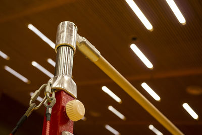 Low angle view of illuminated lighting equipment hanging on ceiling