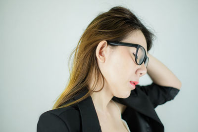 Portrait of beautiful young woman against white background