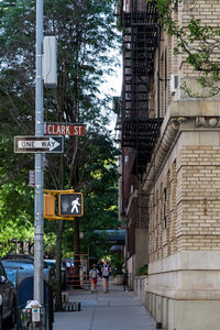 Road sign by building in city