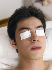 Man having spa treatment while lying on massage table