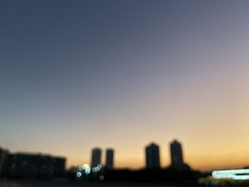 Close-up of buildings against clear sky at sunset