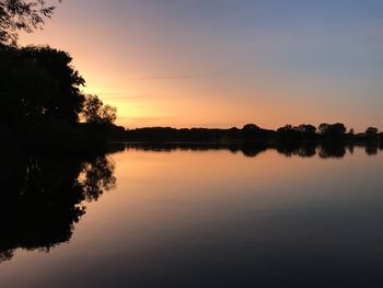 Scenic view of lake against sky during sunset