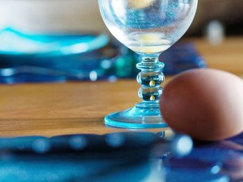 Close-up of glass with ball on table