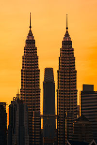 Modern buildings against sky during sunset