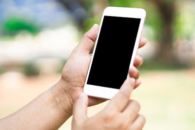 Close-up of hand holding mobile phone