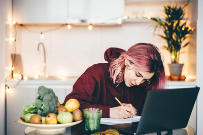 Young woman using laptop at home