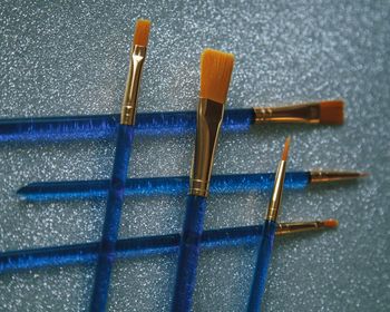 High angle view of clothespins on floor against blue background