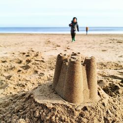 Child playing on beach in winter