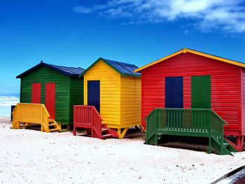  beach huts against blue sky