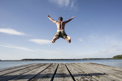 Rear view of mature man diving into sea