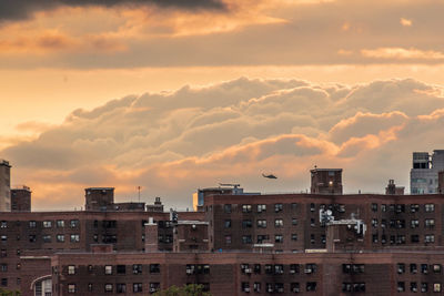 Buildings against sky during sunset