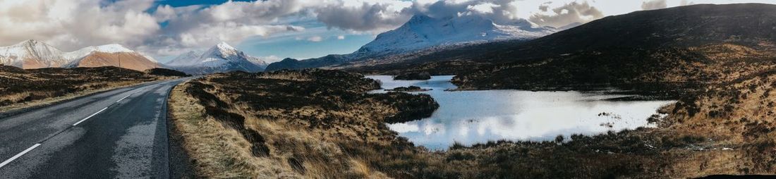 Panoramic view of road amidst mountains against sky