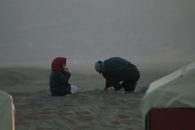 Rear view of man holding water