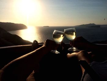 Close-up of beer on beach during sunset