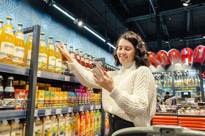 Portrait of young woman standing in store