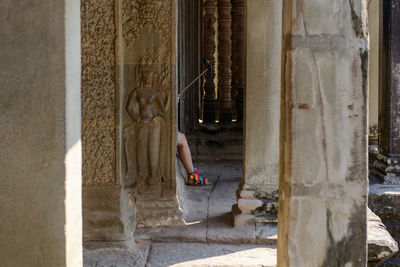 Low section of man standing in front of building