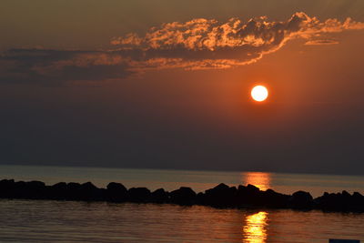 Scenic view of sea against romantic sky at sunset