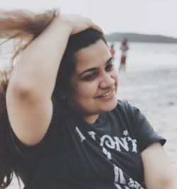 Portrait of smiling young woman on beach