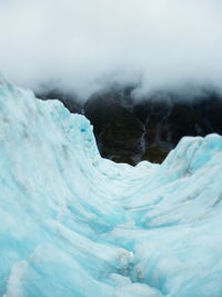 Close-up of frozen landscape against sky