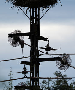 Low angle view of communications tower against sky