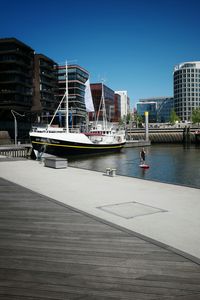 Boats in river with buildings in background