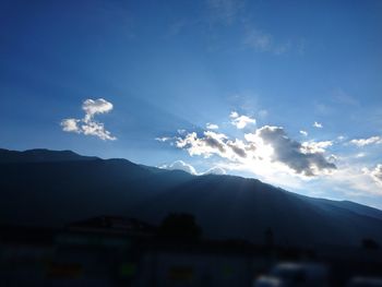 Scenic view of mountains against cloudy sky