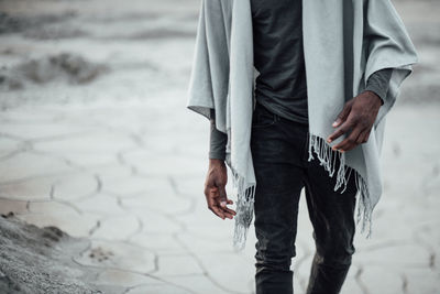 Midsection of man standing on beach