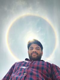 Low angle view of man looking away against sky