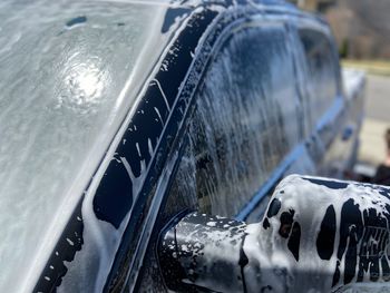 Close-up of wet car windshield during winter