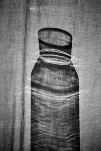 Rear view of man painting on wood