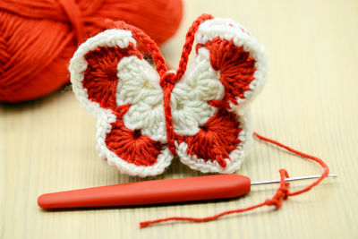 Close-up of crochet with wool on table