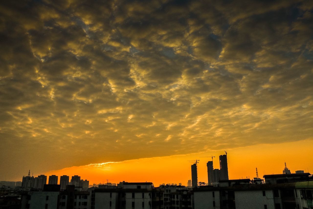 sunset, building exterior, architecture, built structure, sky, orange color, cloud - sky, city, silhouette, cloudy, cloud, residential structure, dramatic sky, residential building, building, low angle view, cityscape, outdoors, beauty in nature, nature