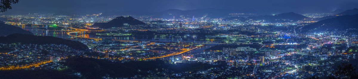 High angle view of illuminated city buildings at night