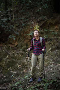 Full length of a young woman in forest