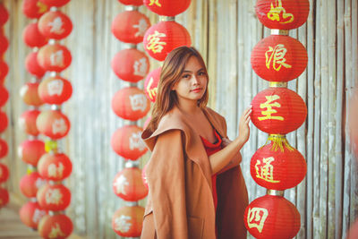 Asian woman wearing cheongsam traditional red dress on chinese new year travel.