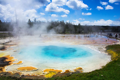 Scenic view of beach against cloudy sky