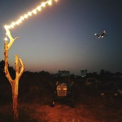 Car against illuminated sky at night