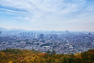 High angle view of city buildings against sky