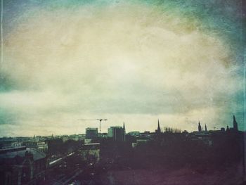 View of cityscape against cloudy sky